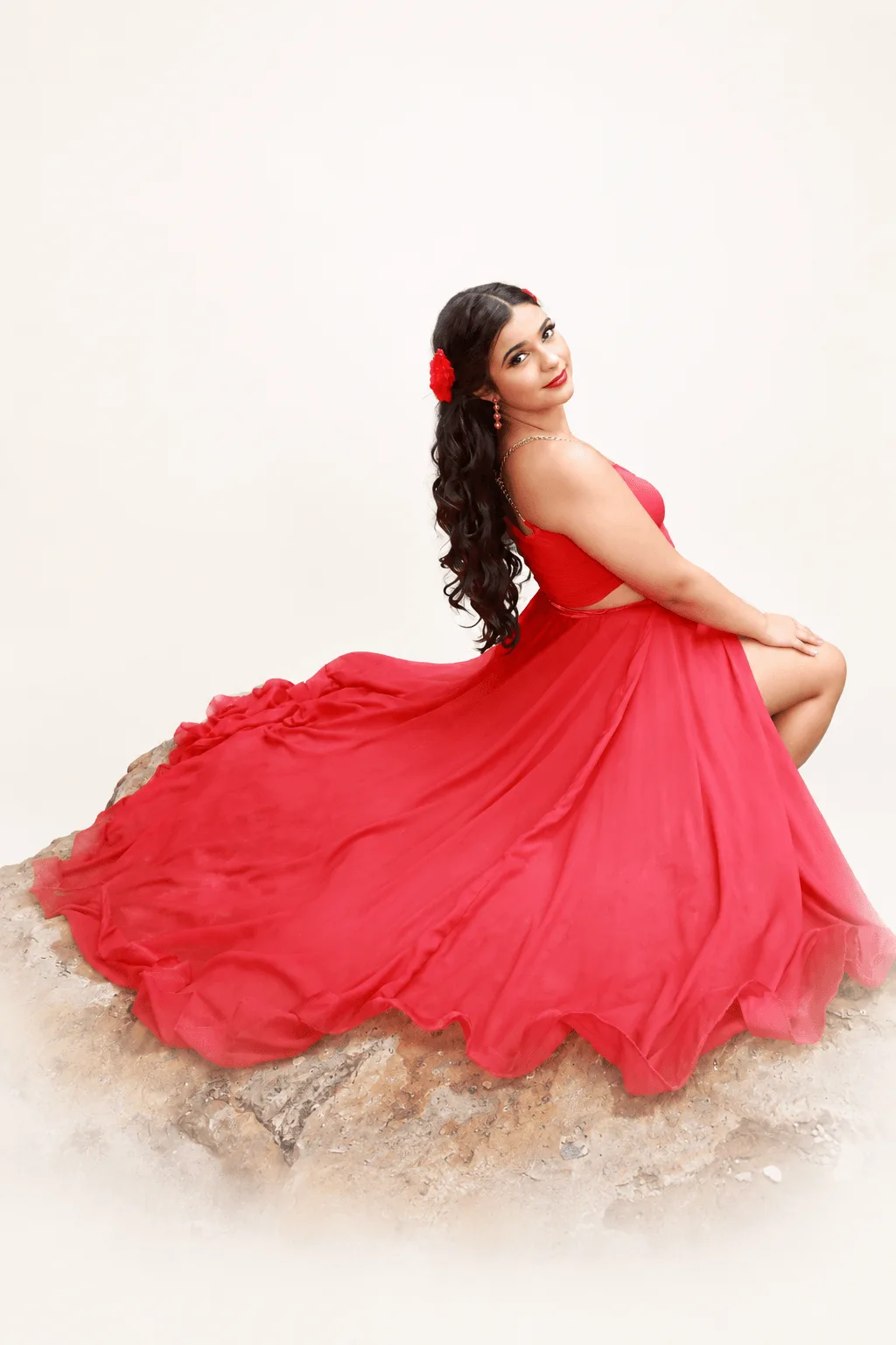 Editorial style outdoor portrait with a flowing red dress showing creative composition