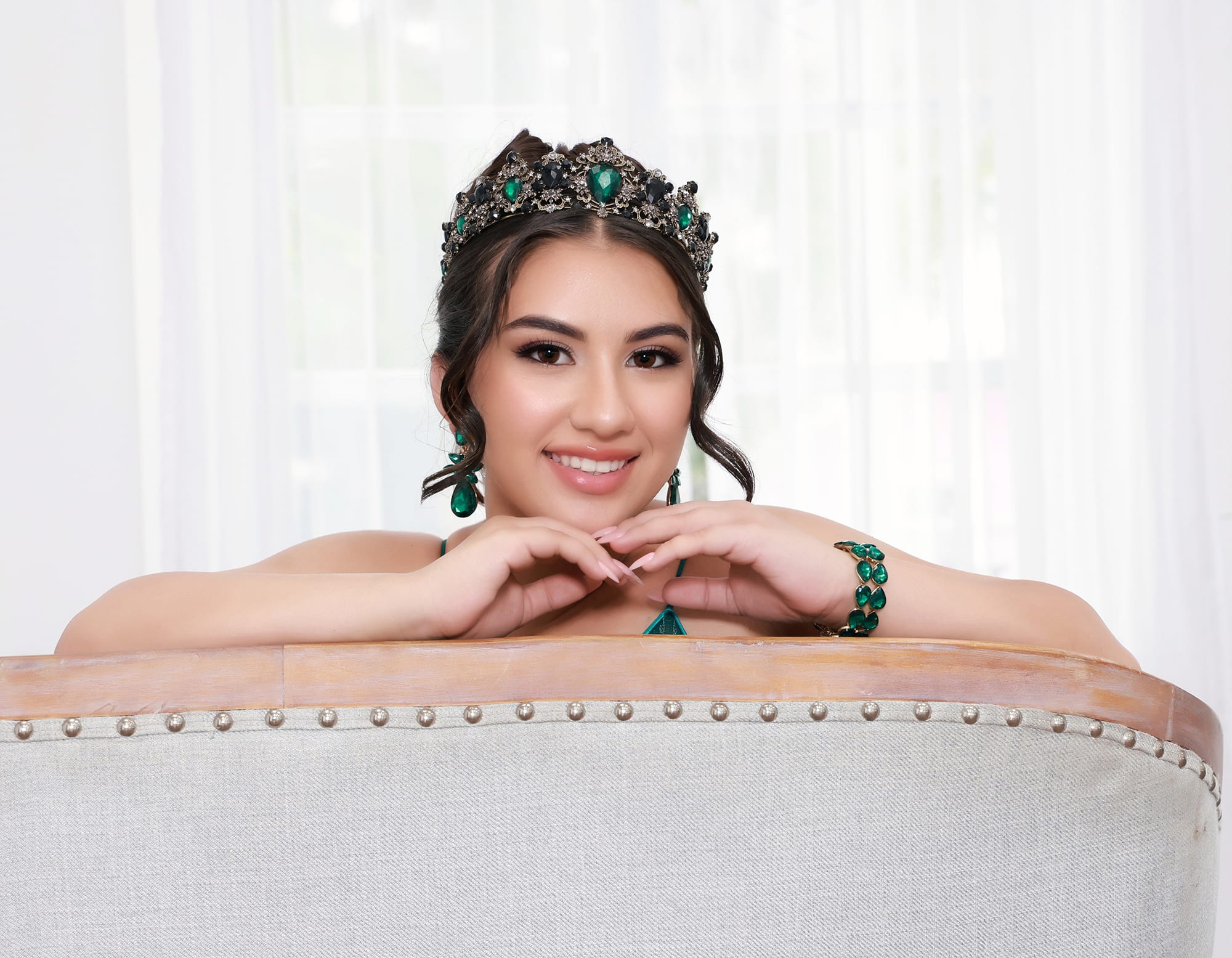 Quinceanera wearing an emerald green dress representing tranquility and renewal